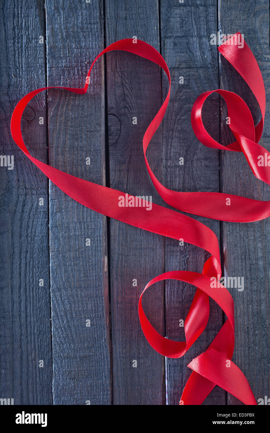 red heart ribbon on the wooden background Stock Photo - Alamy