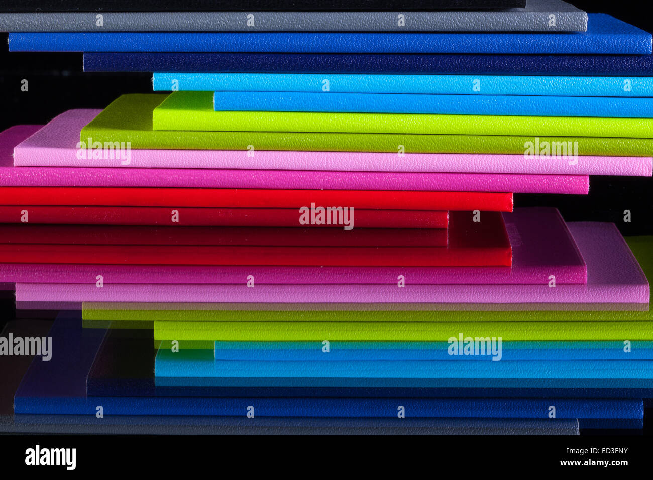 Twelve different colors diaries on a glass desk Stock Photo