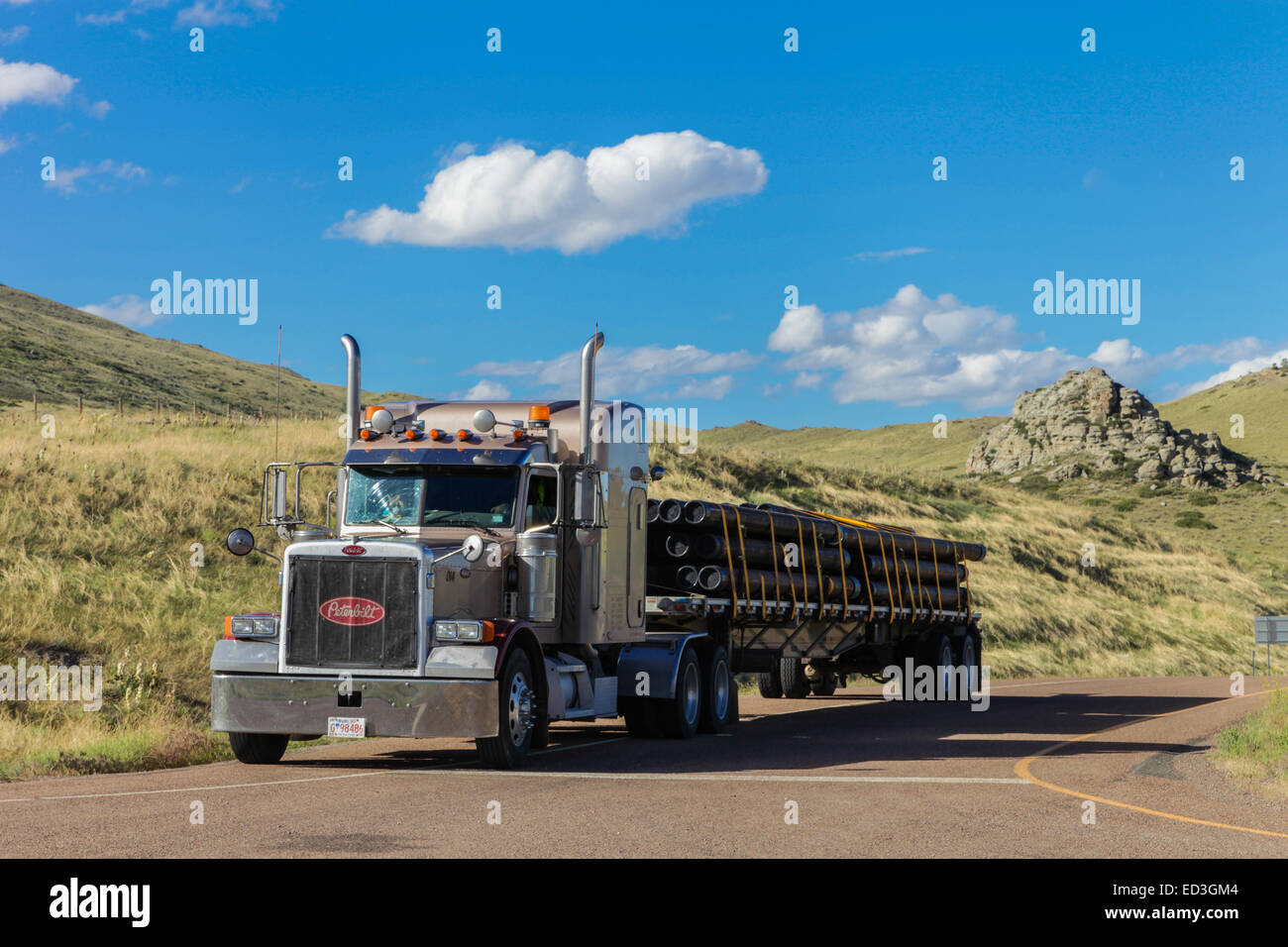 Steel pipe on a Peterbilt 379  flatdeck trailer carrying steel pipe Stock Photo