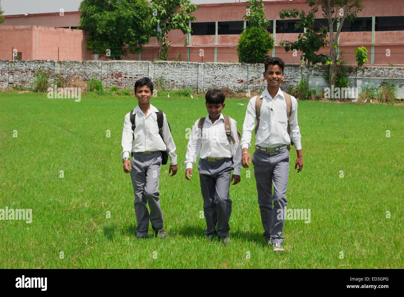 3 indian rural children School Students walking park Stock Photo