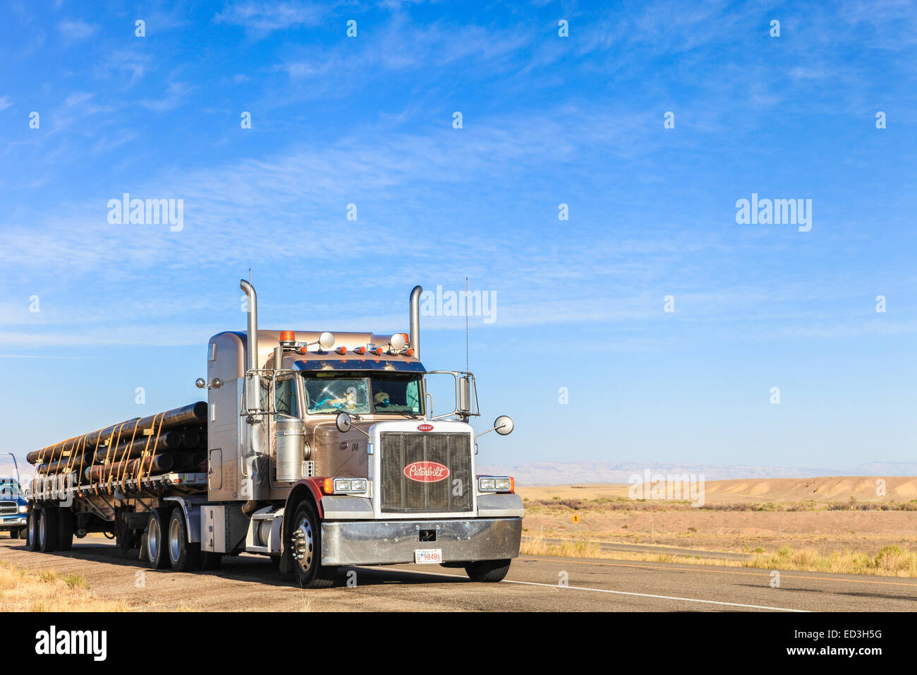 Steel pipe on a Peterbilt 379 flatdeck trailer carrying steel pipe for coal mines Stock Photo