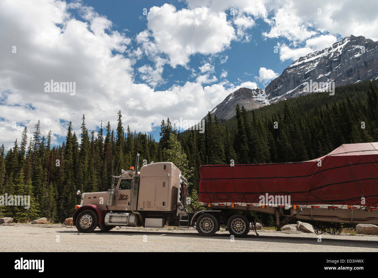 Rogers Pass, BC Canada, Peterbilt 379 parked with load of covered lumber on trailer Stock Photo