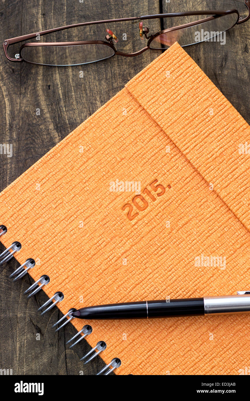 New beginning, new notebook and pen on rustic background Stock Photo