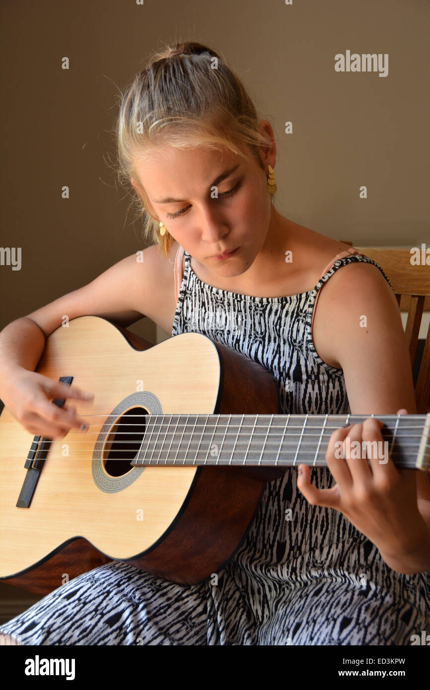 Teenage girl playing acoustic guitar Stock Photo - Alamy