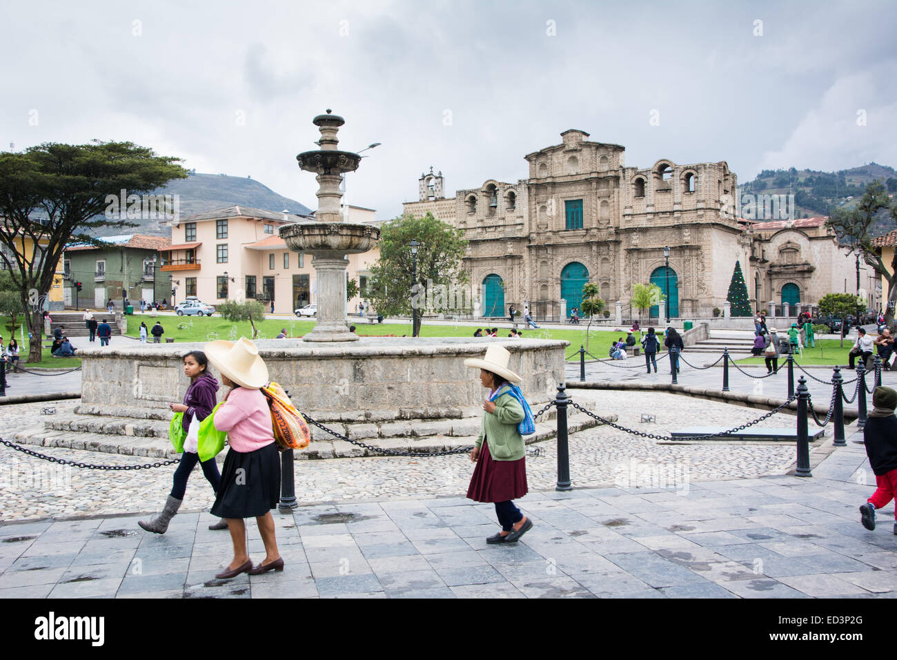 Main square of Cajamarca city in norther peru with locals in traditional dress and hats walking through Stock Photo