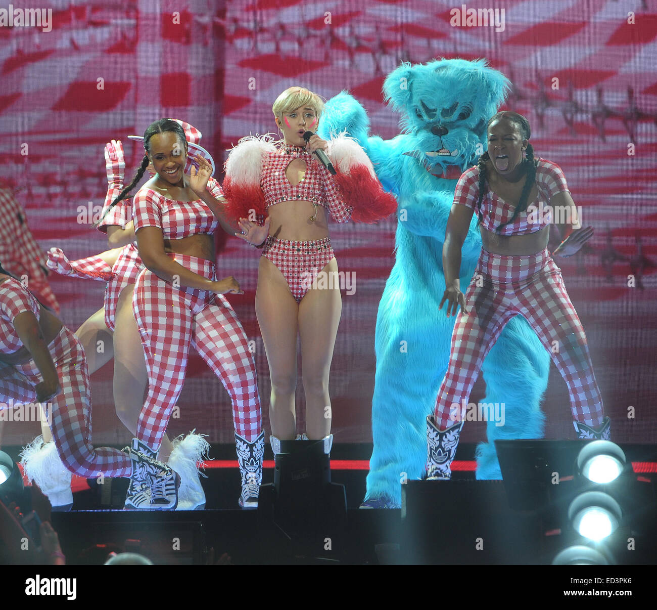 Miley Cyrus performs in a series of wacky outfits at the Ziggo Dome, for the final date of her European 'Bangerz' Tour. Miley spat water over her fans, and pretended to smoke a giant cardboard joint, given to her by someone in the crowd  Featuring: Miley Stock Photo
