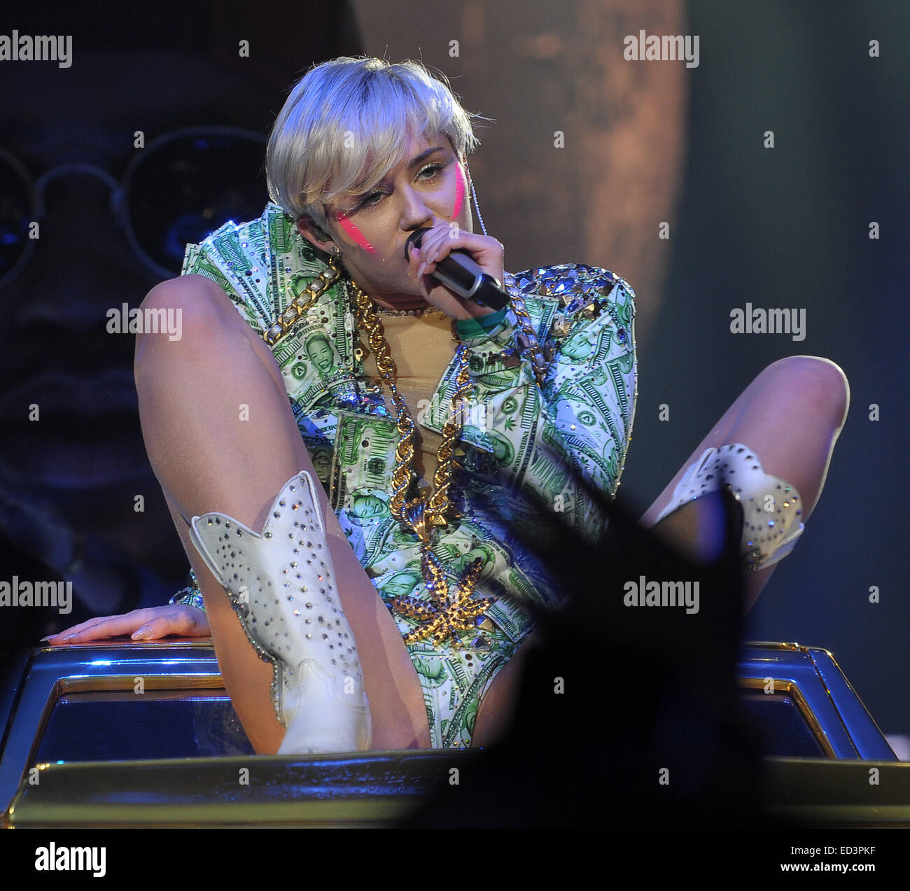 Miley Cyrus performs in a series of wacky outfits at the Ziggo Dome, for the final date of her European 'Bangerz' Tour. Miley spat water over her fans, and pretended to smoke a giant cardboard joint, given to her by someone in the crowd  Featuring: Miley Stock Photo