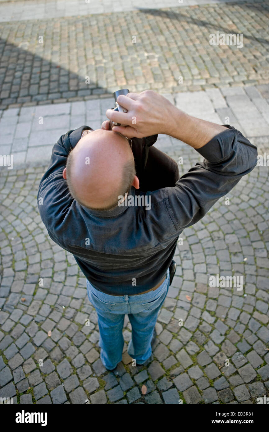 High-angle shot, photographer with a bald head Stock Photo