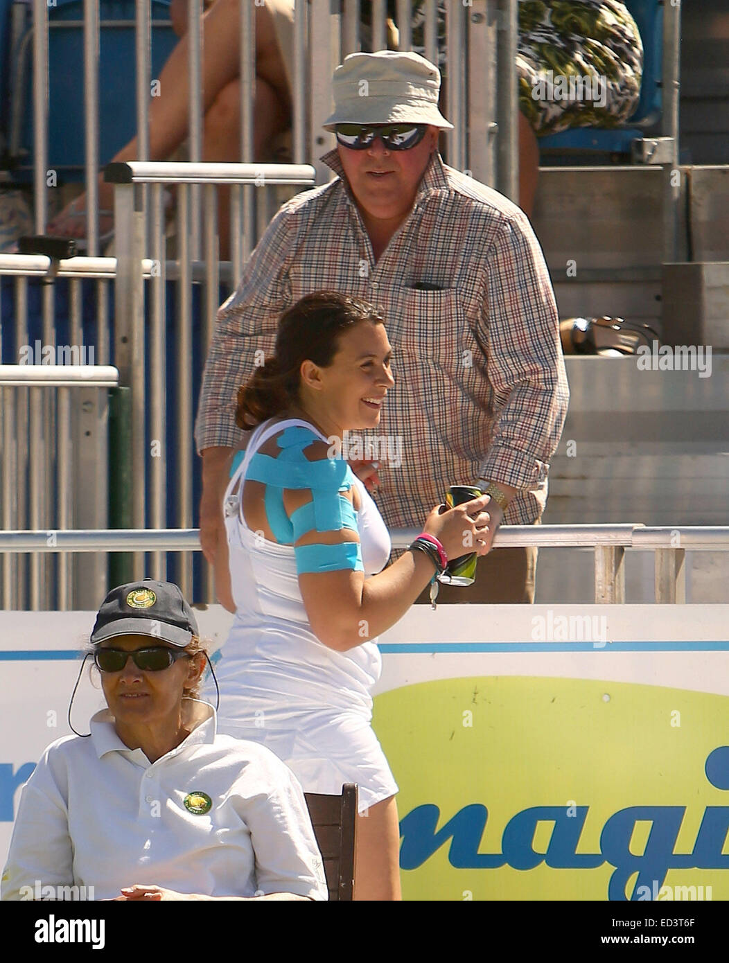Marion Bartoli cheekily asks a fan if she can have a one of his cans of cider for her tennis partner, former player and Sky pundit Barry Cowan, during their doubles match at the Liverpool Hope University International Tennis Tournament. While Cowan supped Stock Photo