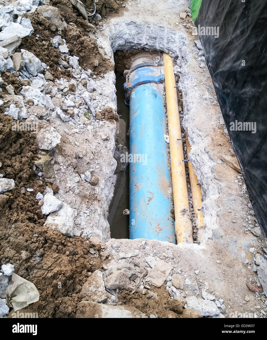 Water pipeline near footpath in the city. Stock Photo