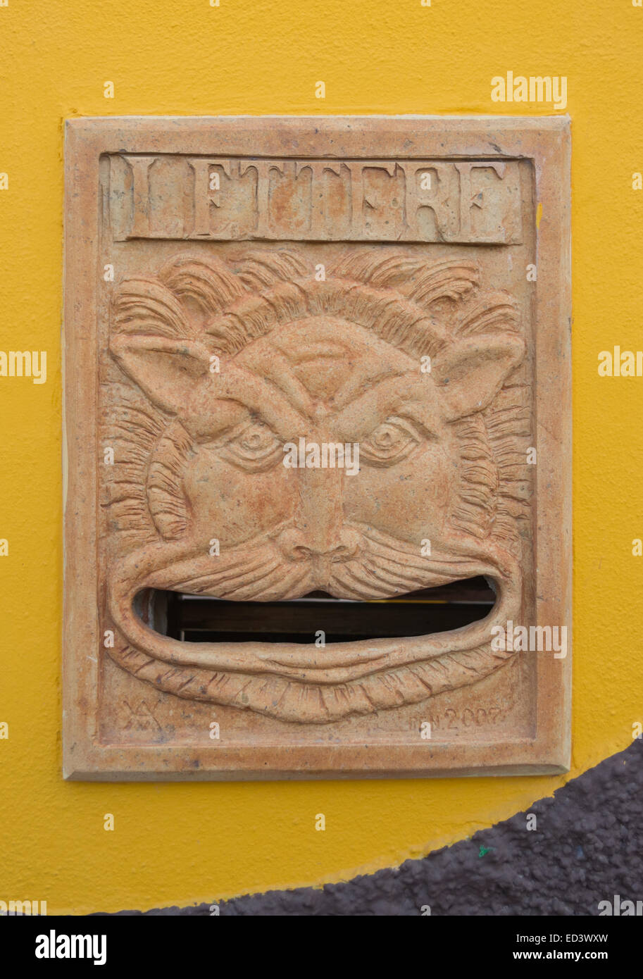 mailbox art. a ceramic face invites the postman to enter letters into her big mouth Stock Photo