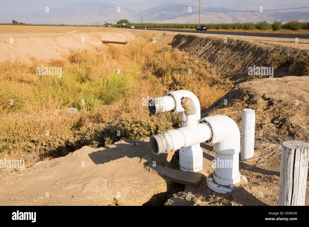 An empty farmers water hole in California's Central Valley, which is in