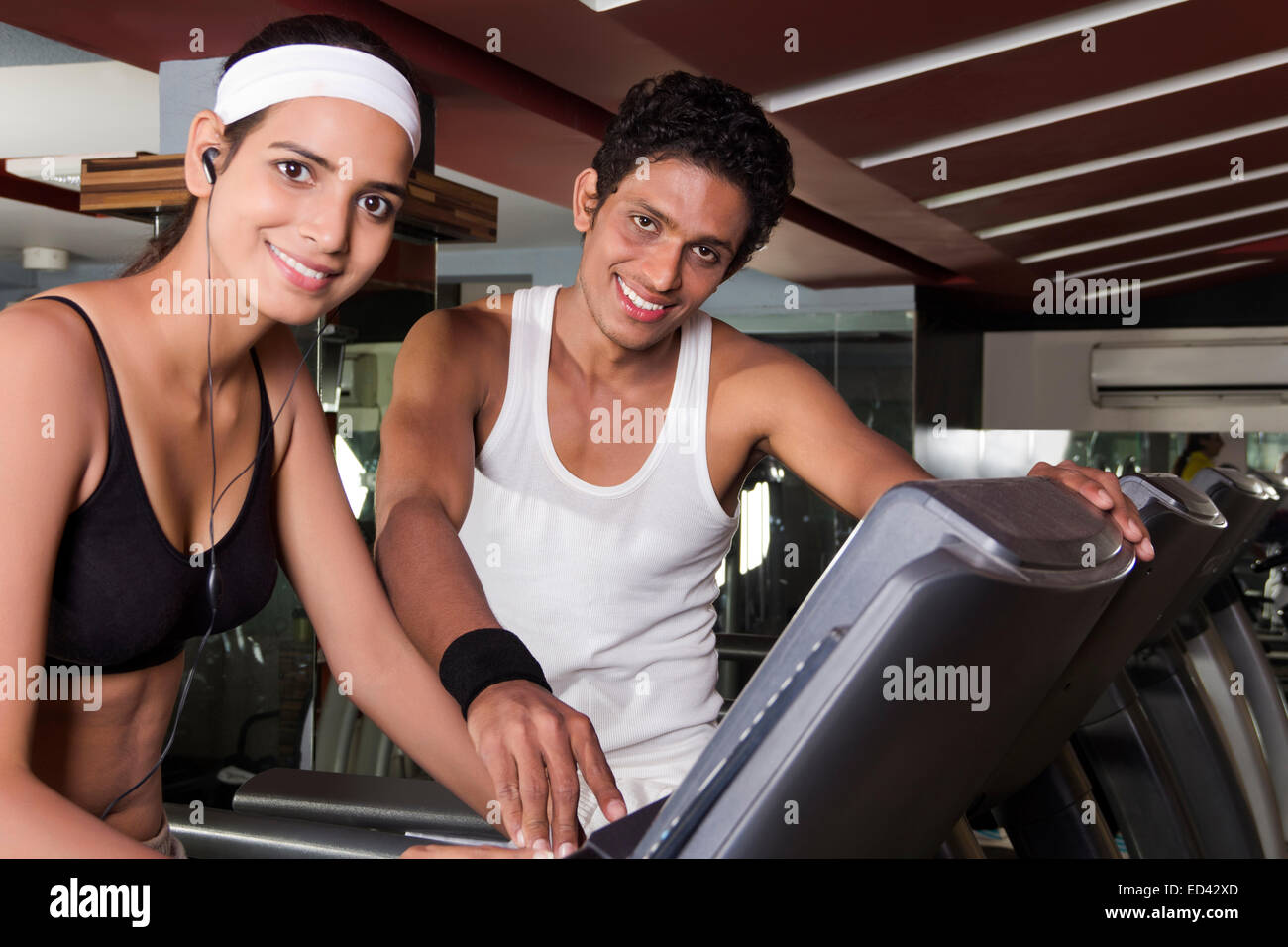indian sports Trainer and lady tread Mill  Running Stock Photo