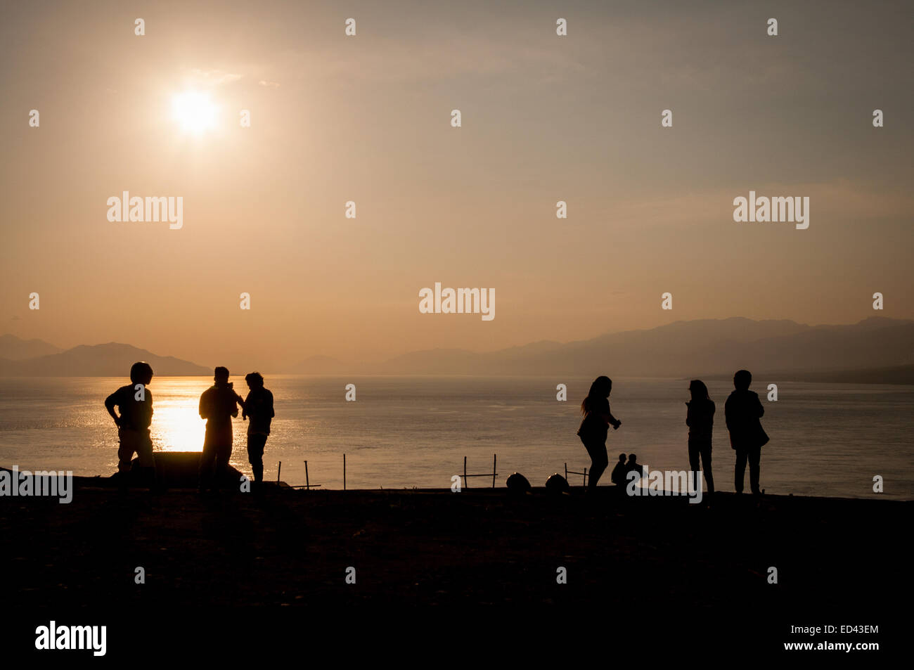 People are enjoying recreational time before sunset at a public recreational space in Waijarang, Lembata, East Nusa Tenggara, Indonesia. Stock Photo