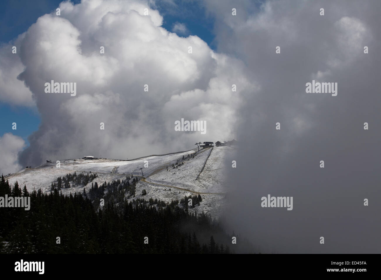 Cloud  mist and snow  on The Schmittenhohe & surrounding mountains  above Zell am See  Salzburgerland Austria Stock Photo
