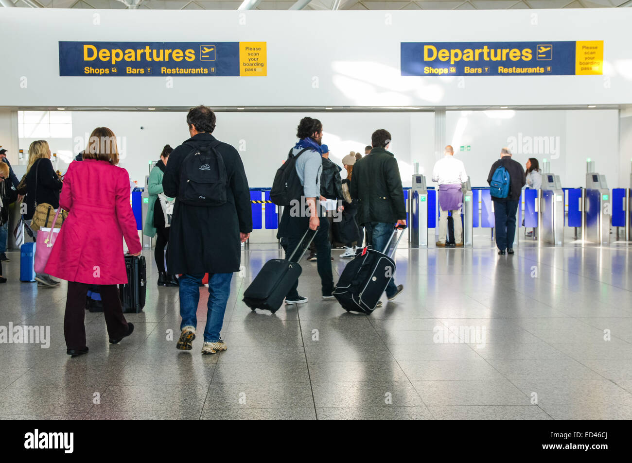 Passengers and travelers going through to Departures zone at London Stansted Airport Essex England United Kingdom UK Stock Photo
