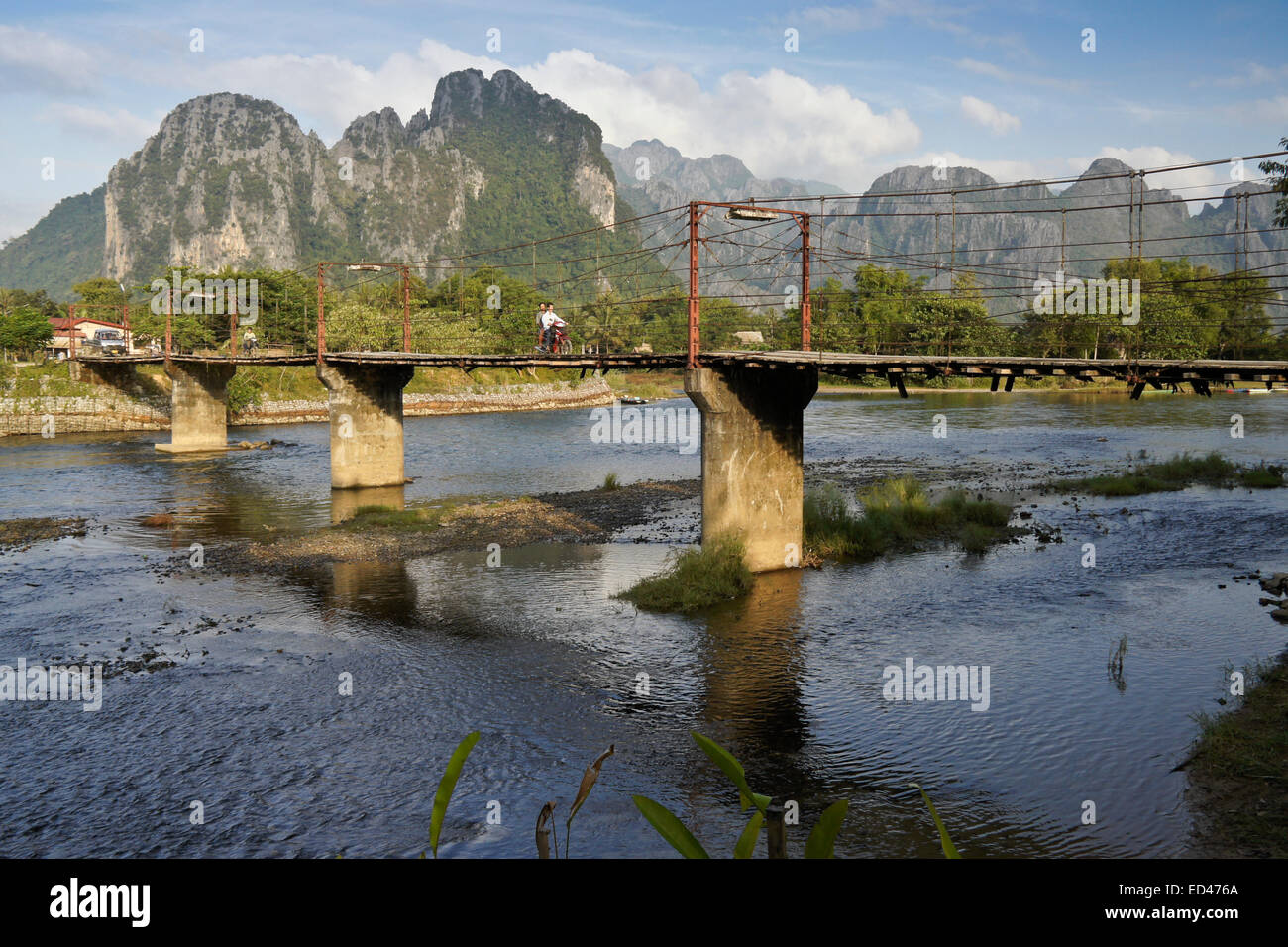 Karst mountains and bridge across Song River, Vang Vieng, Laos Stock Photo