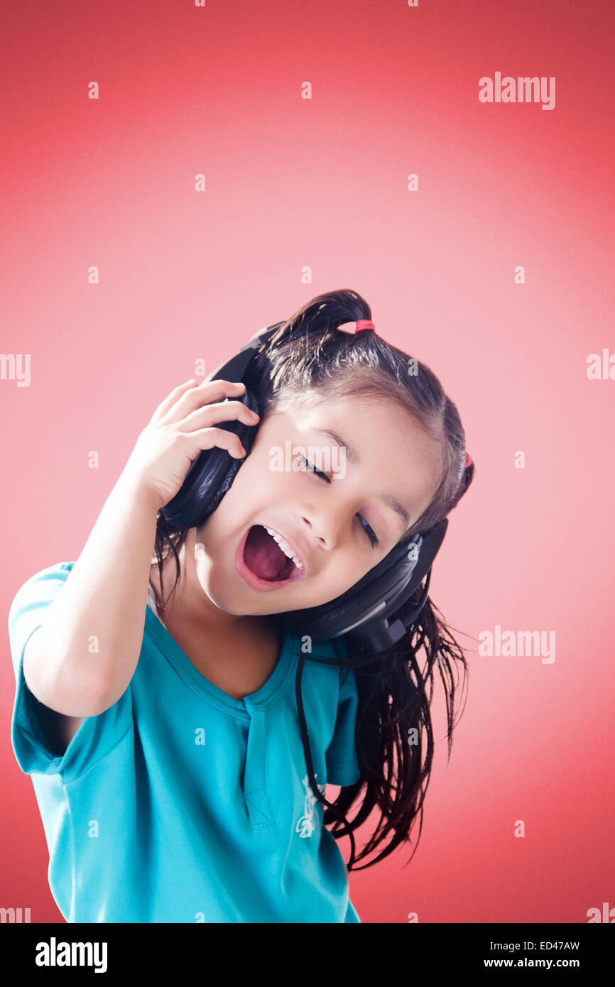 1 indian child girl Headphone Hearing music Stock Photo