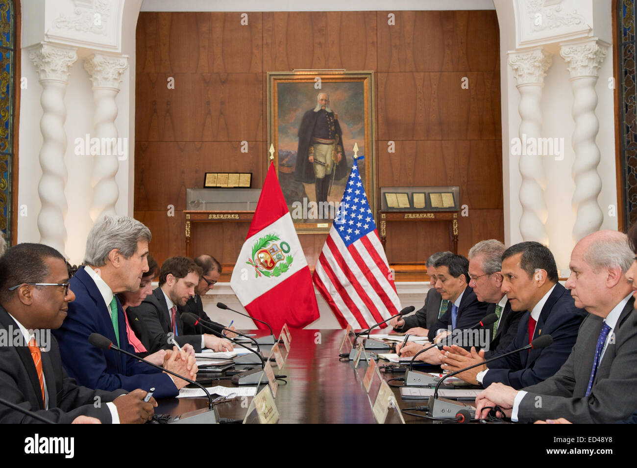 U.S. Secretary of State John Kerry and President Ollanta Humala of Peru, joined by their respective advisers, sit across from each other at the outset of a bilateral meeting in the Presidential Palace in Lima, Peru, on Dec. 11, 2014, and after the Secretary addressed the 20th session of the Conference of the Parties to the United Nations Framework Convention on Climate Change. Stock Photo