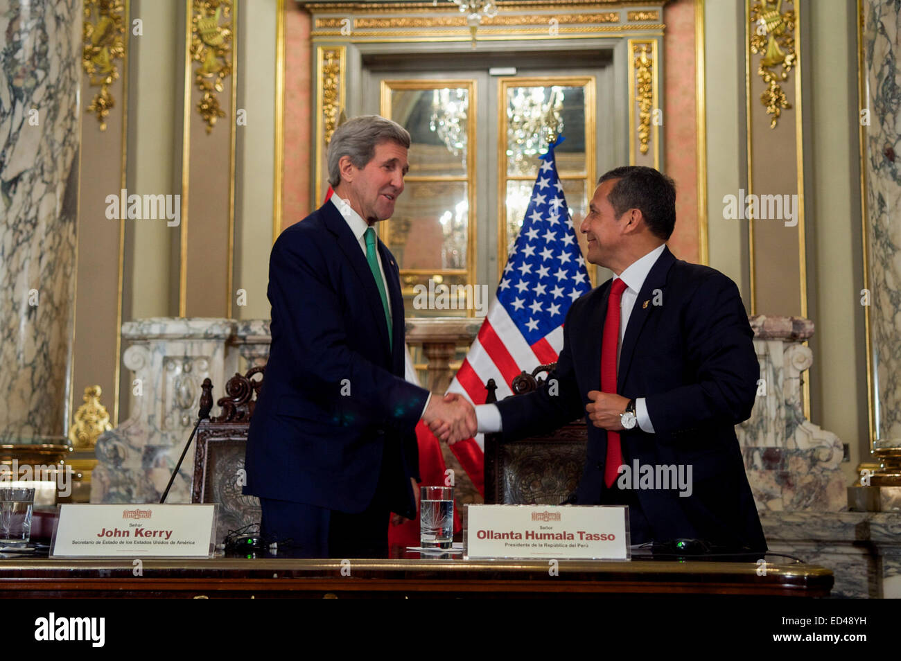 U.S. Secretary of State John Kerry and President Ollanta Humala of Peru shake hands after delivering a pair of statements to news reporters that followed a bilateral meeting in the Presidential Palace in Lima, Peru, on Dec. 11, 2014, and after the Secretary addressed the 20th session of the Conference of the Parties to the United Nations Framework Convention on Climate Change. Stock Photo