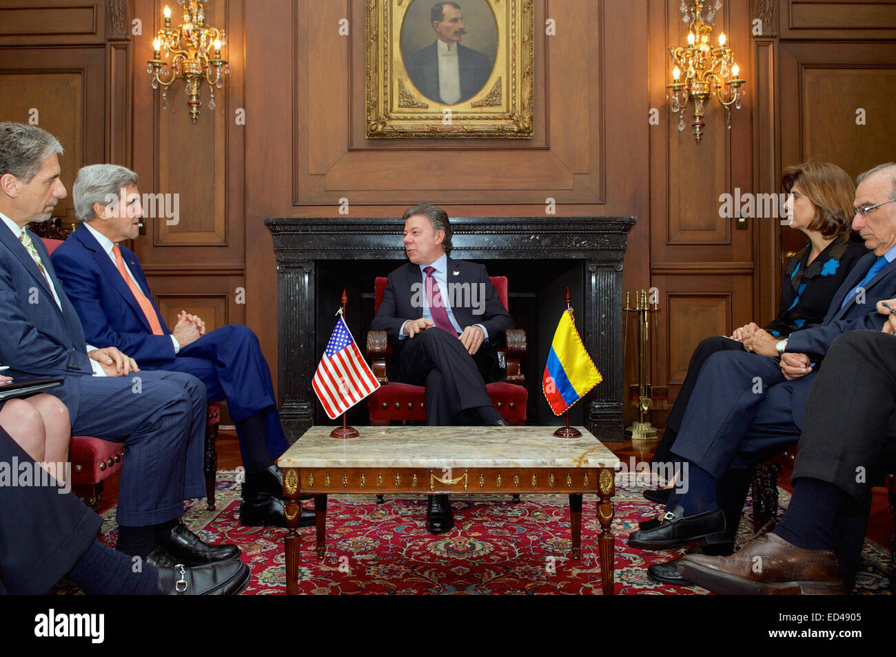 Colombian President Juan Manuel Santos chats with U.S. Secretary of State John Kerry and U.S. Ambassador to Colombia Kevin Whitaker, seated across from Colombian Foreign Minister Maria Angela Holguin and lead FARC peace negotiator Humberto de la Calle before they begin a bilateral meeting at the Casa de Narino Presidential Palace in Bogota, Colombia, on December 12, 2014. Stock Photo