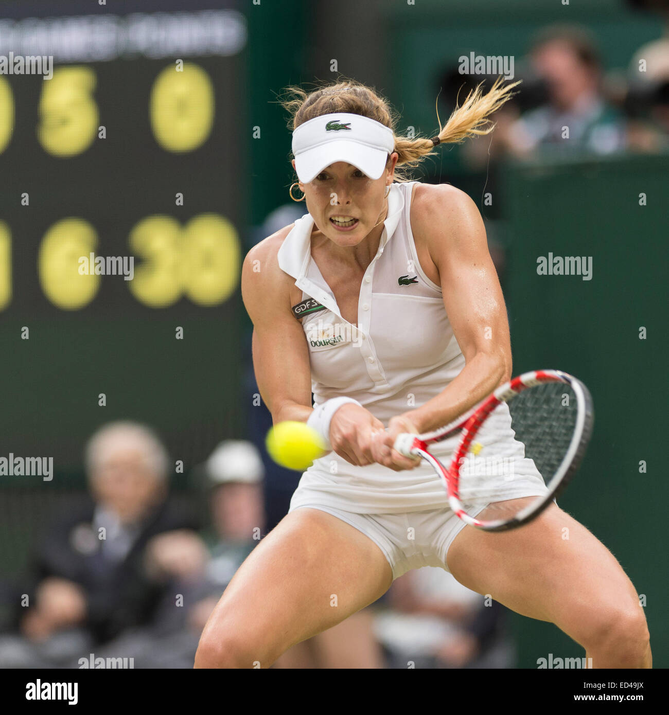 30.06.2014. The Wimbledon Tennis Championships 2014 held at The All England  Lawn Tennis and Croquet Club, London, England, UK. Alize Cornet (FRA) [25]  (collared top, Lacoste/alligator and Boursin branded) v Eugenie Bouchard (