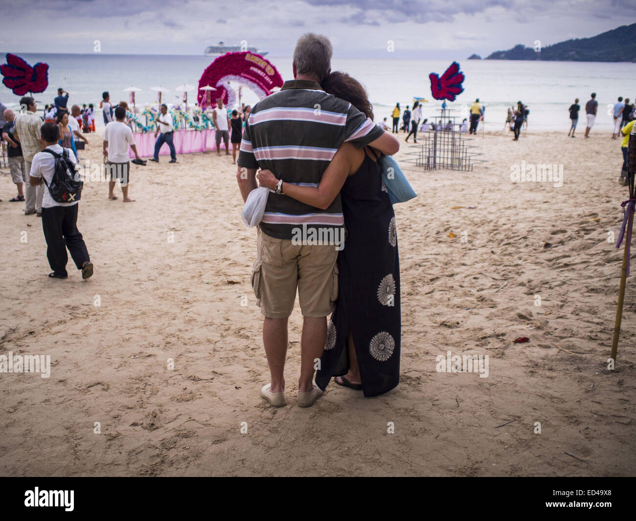 Patong, Phuket, Thailand. 26th Dec, 2014. Tourists watch the memorial for the 2004 tsunami on Patong Beach. Hundreds of people died in Patong and nearly 5400 people died on Thailand's Andaman during the 2004 Indian Ocean Tsunami that was spawned by an undersea earthquake off the Indonesian coast on Dec 26, 2004. Credit:  Jack Kurtz/ZUMA Wire/Alamy Live News Stock Photo