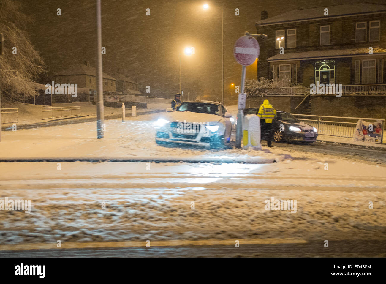 Road traffic accident in heavy snow fall. car skids into street sign Stock Photo
