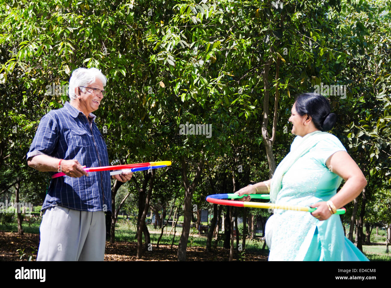 indian Old married couple park playing Hula Hoop Stock Photo