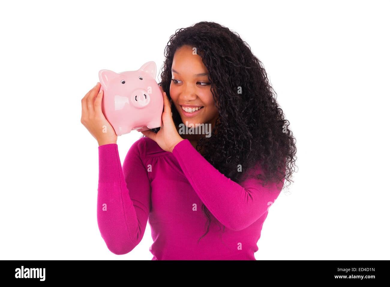 Young african american woman putting coin in piggy bank isolated Stock ...