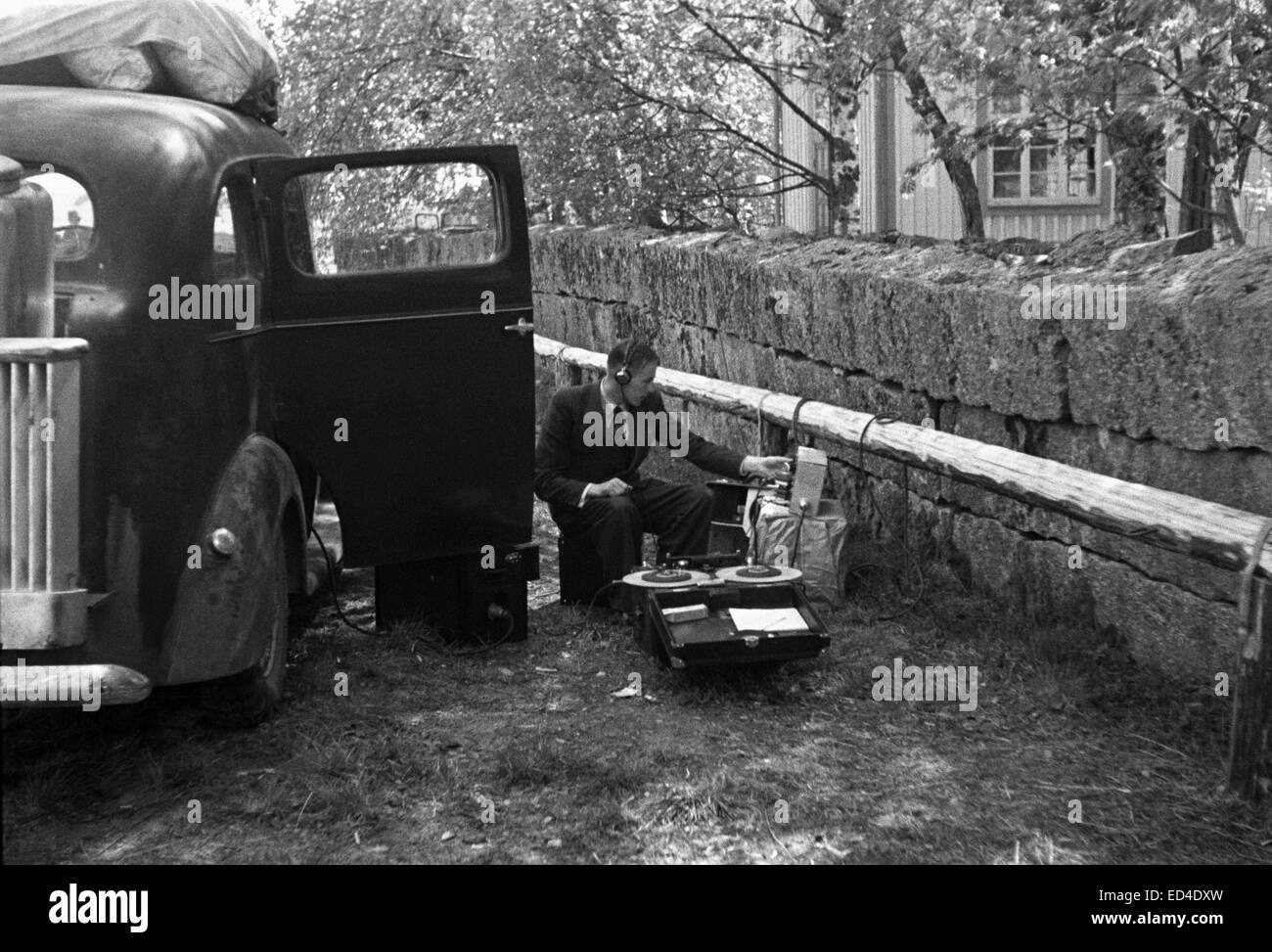 Technician recording a radio programme by a broadcast van for sound, 1939. Stock Photo
