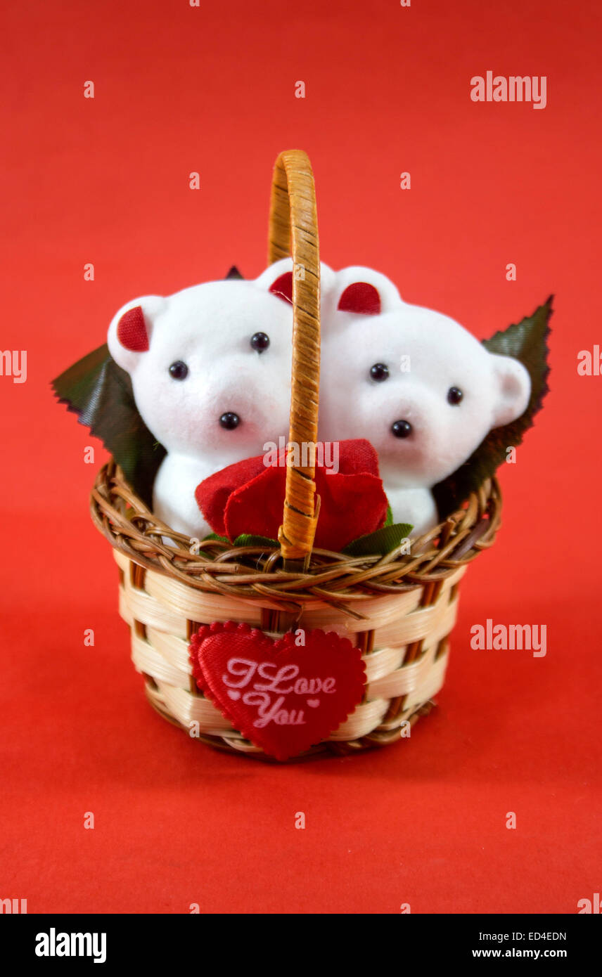 A cute white teddy bears with with rose in basket. Stock Photo