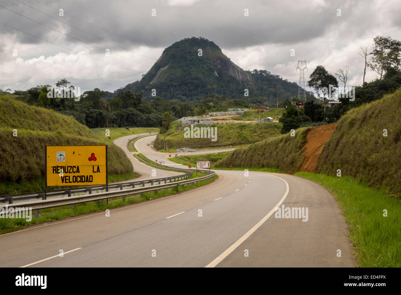 Dual carriageway modern highway past distinctive mountain on way to the new capital city of Oyala, Equatorial Guinea Stock Photo