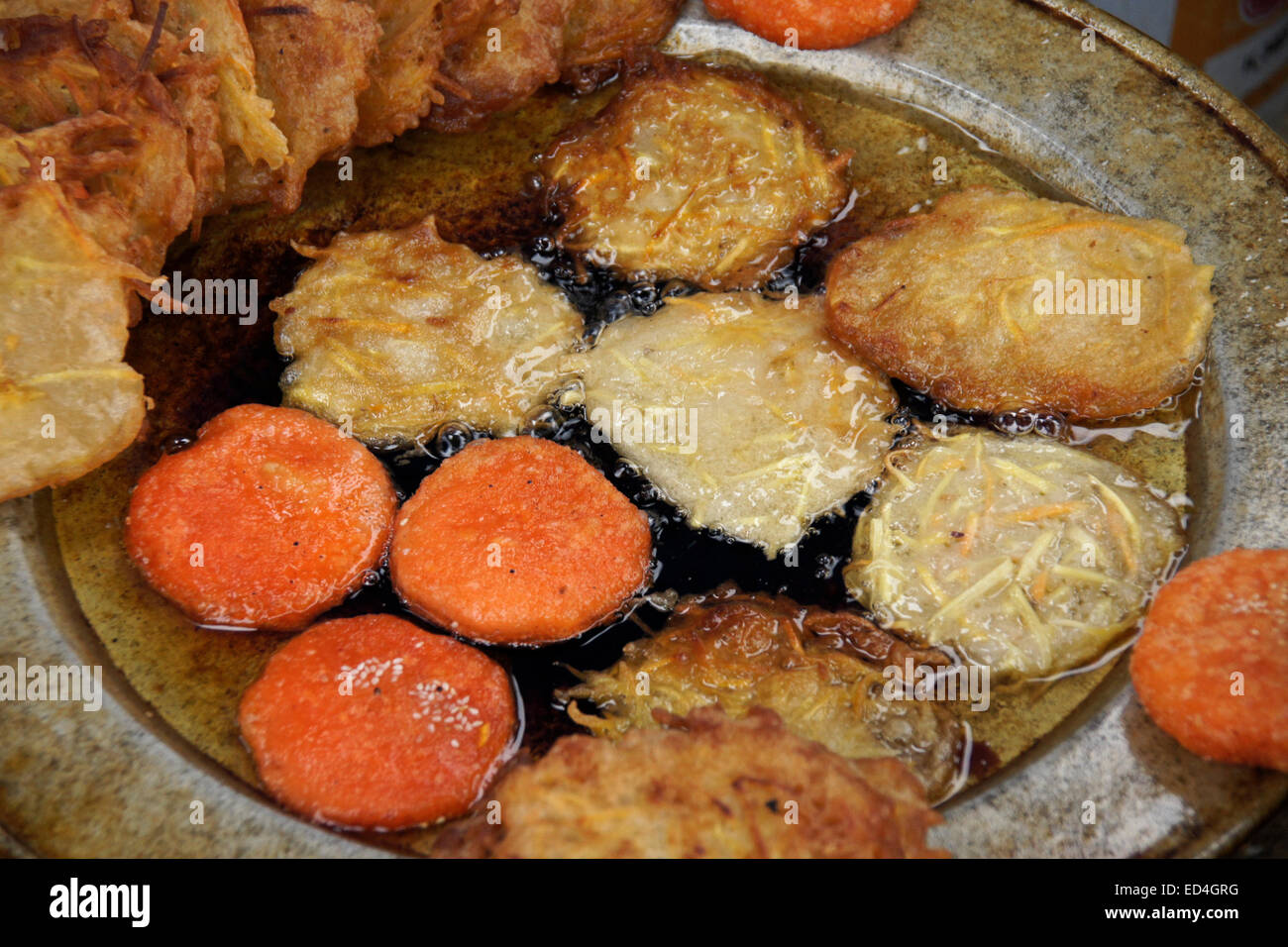 Potatoes and yams frying in oil, Vietnam Stock Photo Alamy