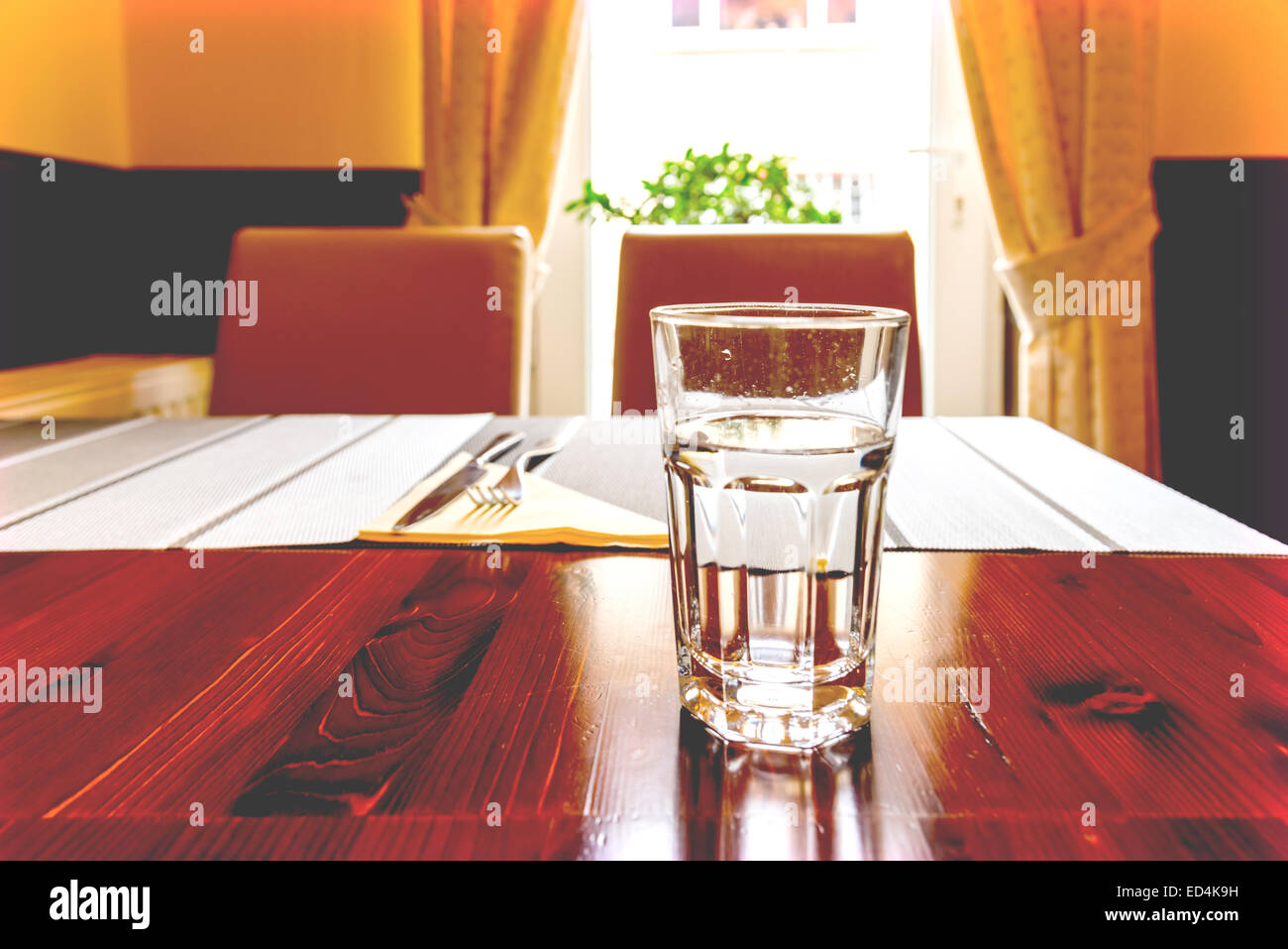 Glass Of Water On Vintage Restaurant Table Stock Photo