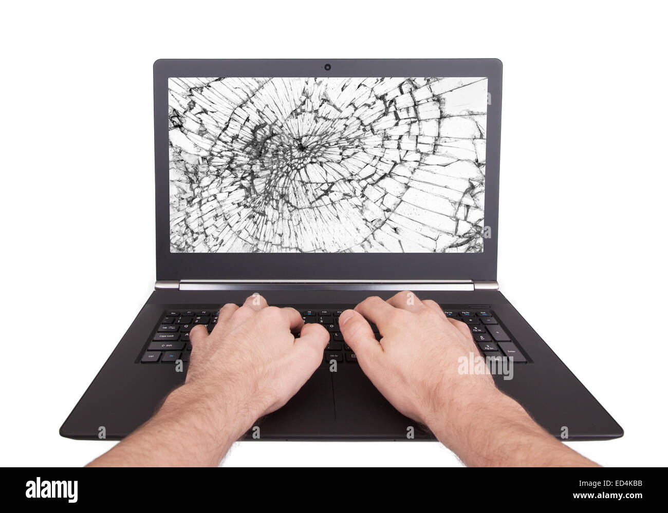 Man working on a laptop with a broken screen, white Stock Photo