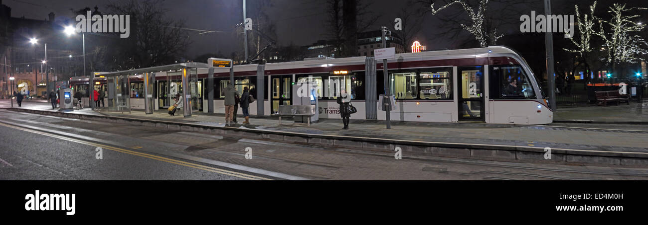 Panorama of a new Edinburgh Tram, bound for York Place, in St Andrew Square at night, Scotland, UK Stock Photo