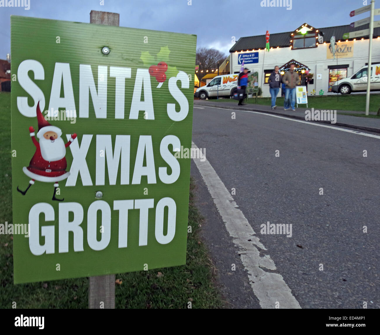 Santa's Xmas Grotto sign, pointing the way at side of road. Getting earlier each year Stock Photo