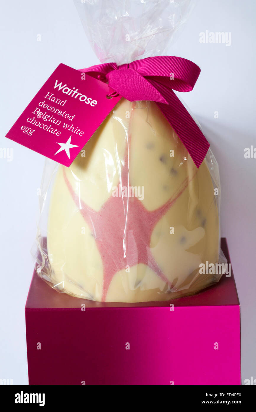 Waitrose hand decorated Belgian white chocolate egg for Easter set on white background Stock Photo