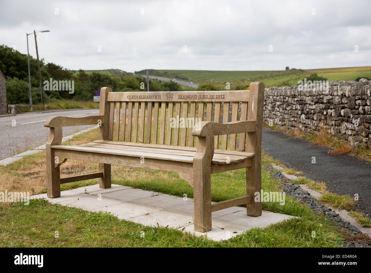 Inscription ' Queen Elizabeth II Diamond Jubilee 2012 ' on bench beside road in Altarnun near Bodmin, Cornwall, UK. Stock Photo