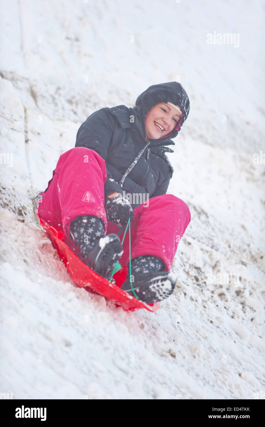 The Horseshoe Pass, Denbighshire, Wales, UK. 27th December, 2014. A young woman enjoys tobogganing at The Horseshoe Pass, approximately 300 metres above sea level. Credit:  Graham M. Lawrence/Alamy Live News. Stock Photo