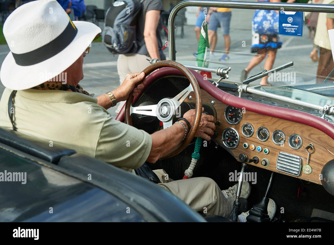 a man drive a white hat in an old car Stock Photo