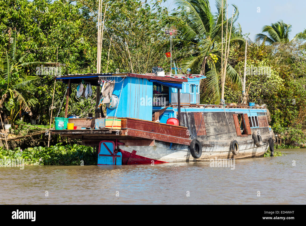 Vietnamese houseboat on a canal of the Mekong River near Phong Dien ...