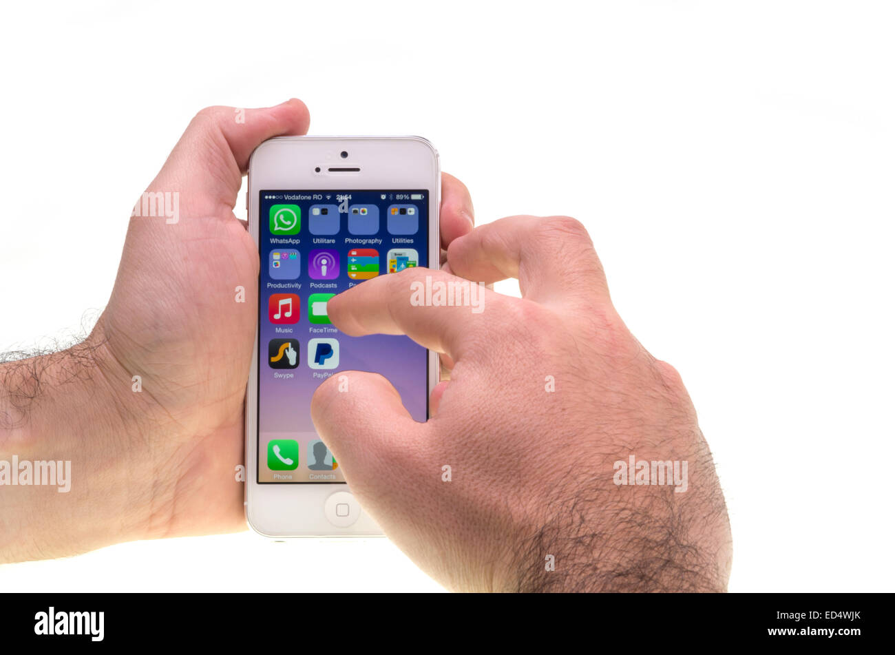 Hands and the new Apple iPhone, many application on screen. Stock Photo