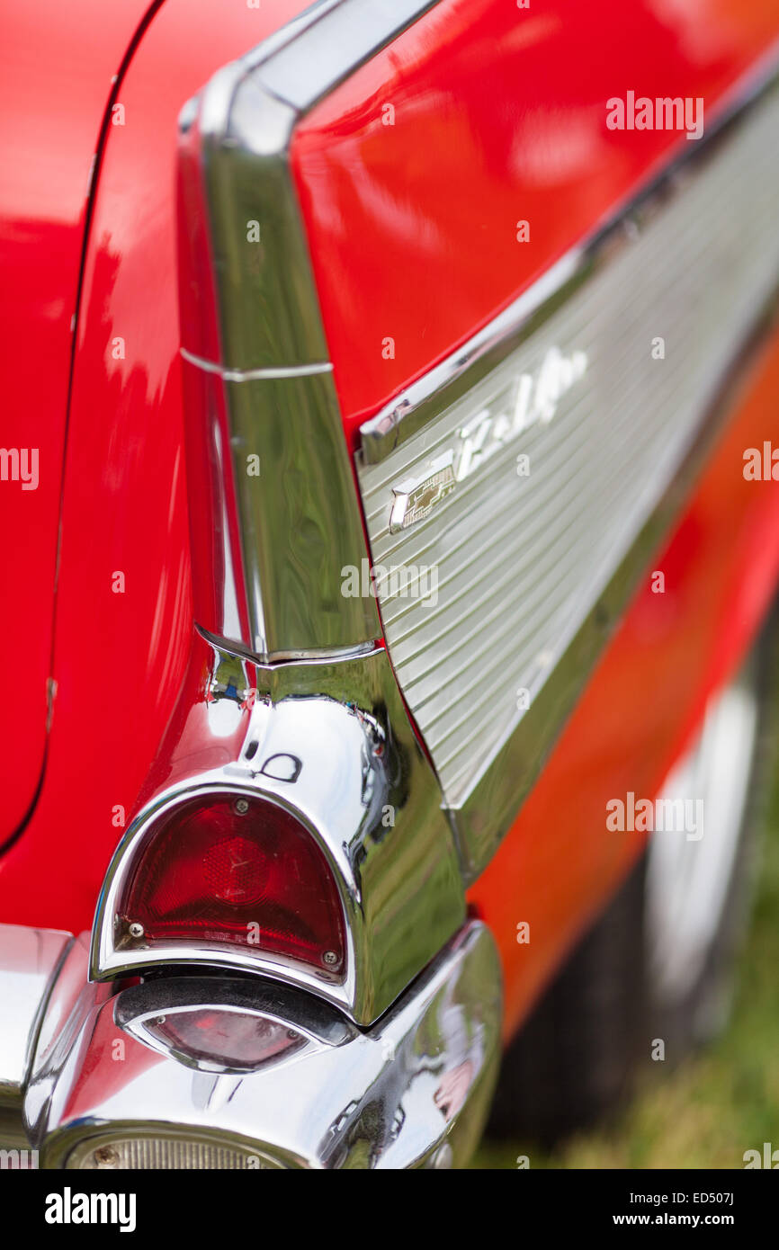Rear light and panel on a restored red and silver vintage classic American car taken at a rally.  Taken in vertical format. Stock Photo