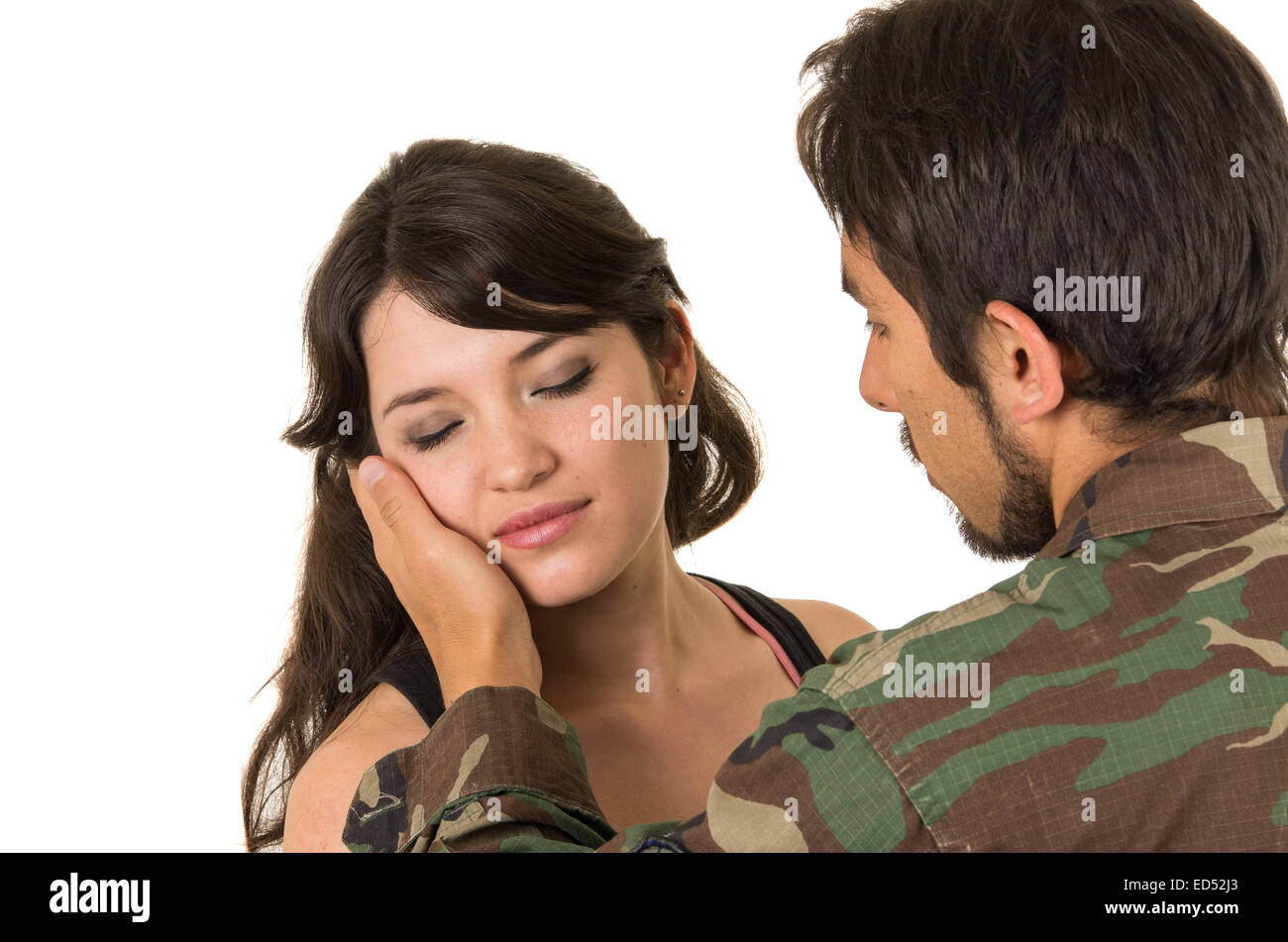 young hispanic military soldier saying goodbye to sad wife Stock Photo