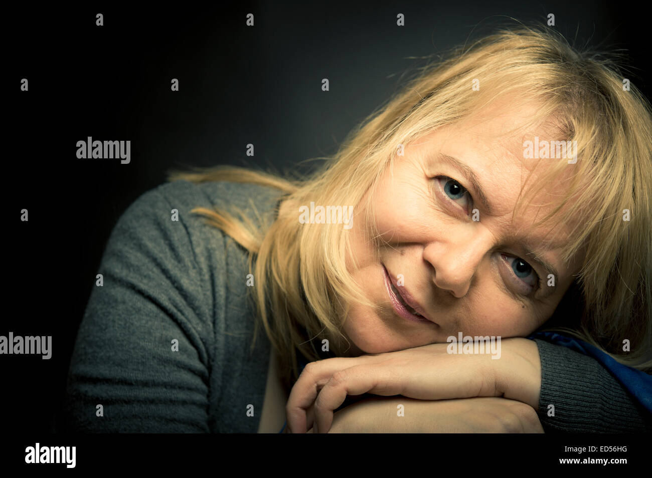 portrait of a blond woman in her forties, happy and satisfied Stock Photo