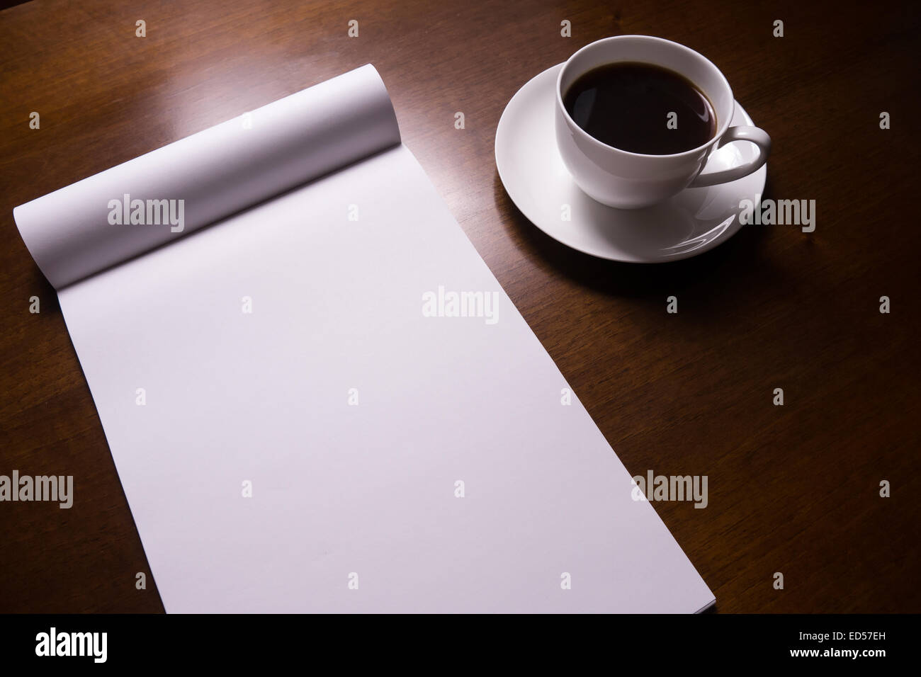 notebook and cup of coffee on desk Stock Photo