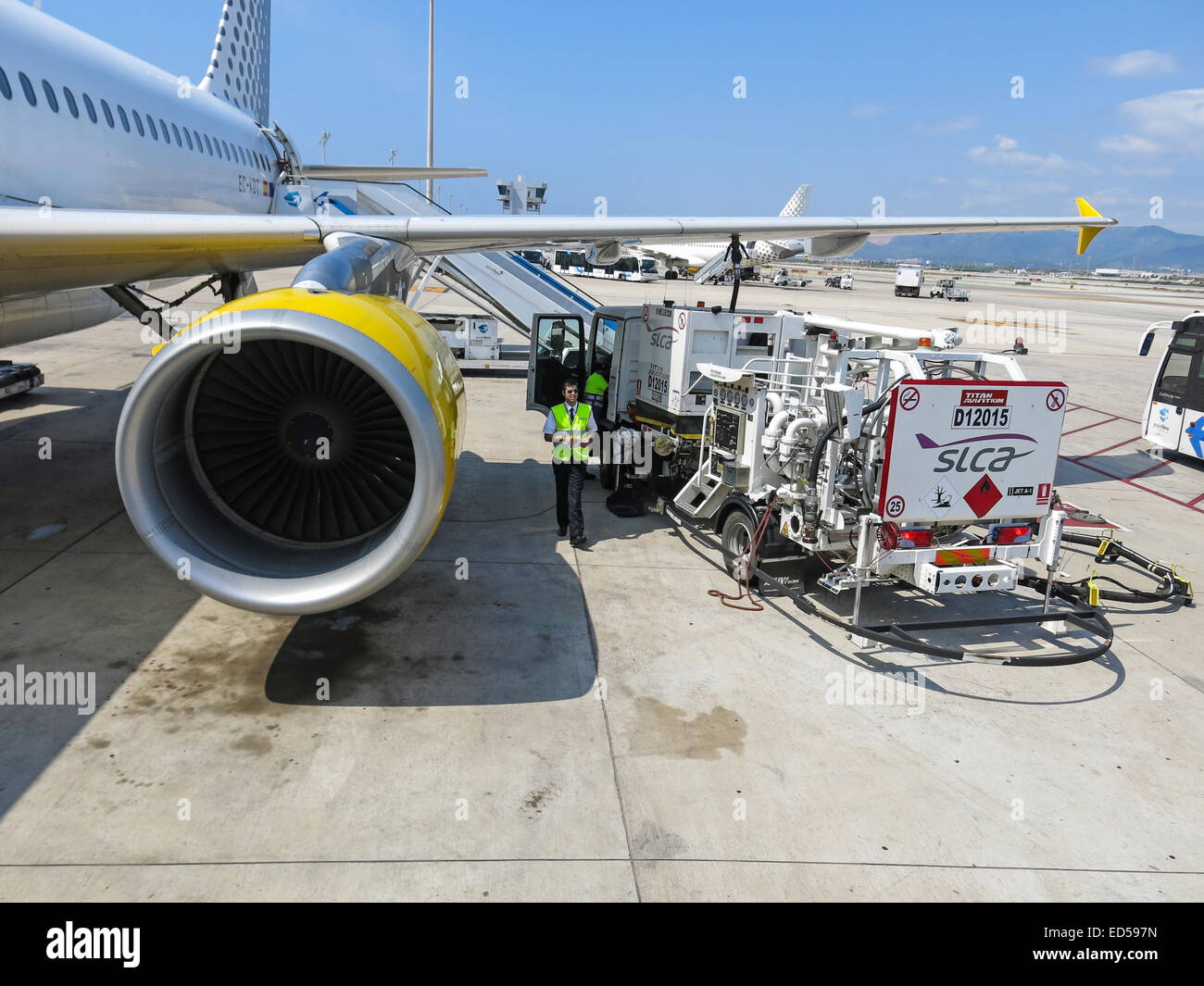 Airbus A320 of the Vueling Airlines receiving fuel from tanker truck at