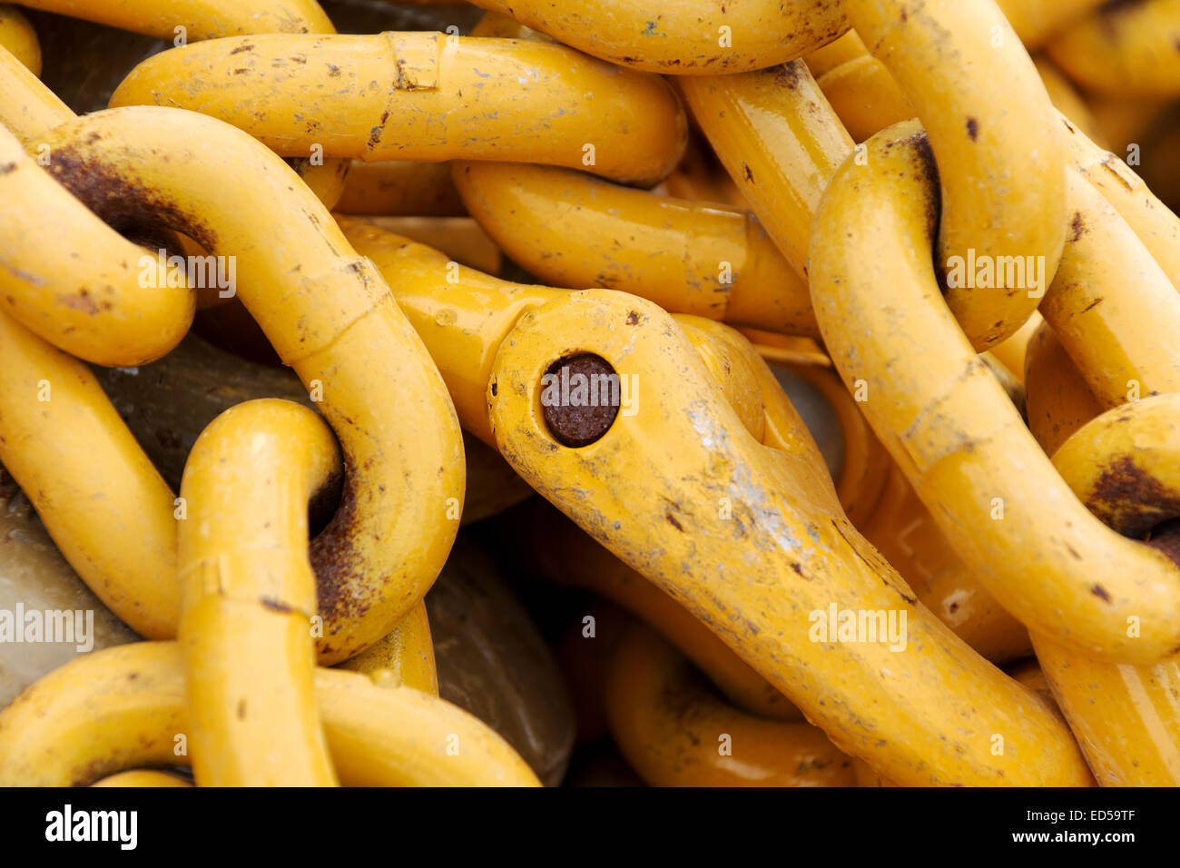 Stack of yellow chain links Stock Photo